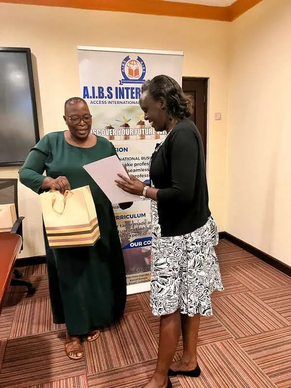 Presenting a gift to a participant at an AIBS training